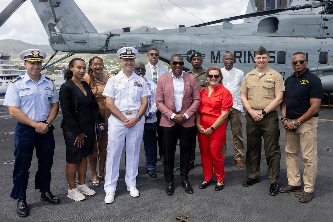 Capt. Thomas Uhl, commanding officer of San Antonio-class amphibious transport dock USS San Antonio (LPD 17), poses for a photo with Dr. Terrance Drew, Prime Minister of Saint Kitts and Nevis and Charge D’Affaires Karin Sullivan, U.S. Embassy Bridgetown, Barbados, and accredited to Saint Kitts and Nevis, along with distinguished guests aboard the San Antonio, Feb. 24, 2026. U.S. military forces are deployed to the Caribbean in support of the U.S. Southern Command mission, Department of War-directed operations, and the president’s priorities to disrupt illicit drug trafficking and protect the homeland. (U.S. Marine Corps photo)