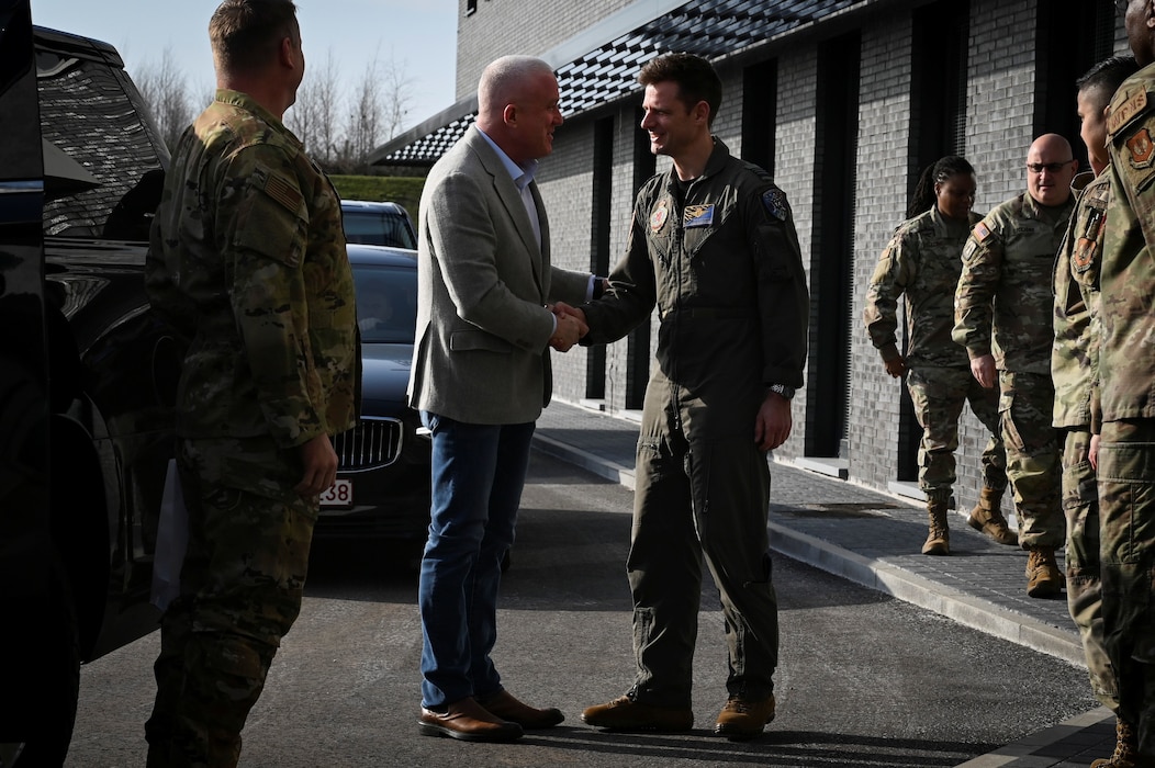 Belgian Air Force Col. Davy Compeers, right, 10th Tactical Wing commander, greets Bill White, U.S. Ambassador to Belgium, during a base visit.