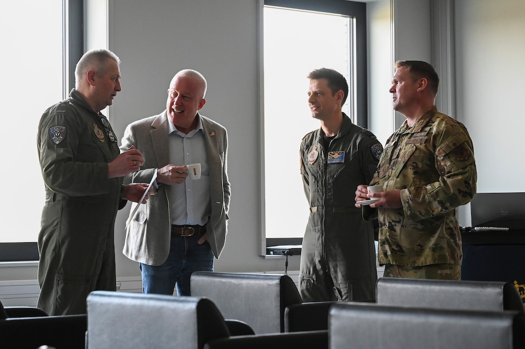 Bill White, center left, U.S. Ambassador to Belgium, and U.S. Air Force Col. Scott Adams, far right, U.S. Embassy Brussels and Luxembourg air attaché, speaks with 10th Tactical Wing leadership during a base visit.