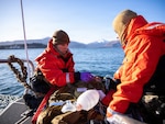 U.S. Navy Lt. Hannah Cunningham, left, assigned to En-route Care System (ERCS) Team 52, and U.S. Navy Hospital Corpsman 1st Class Daniel Rodriguez, right, assigned to ERCS Team 52, treat a patient aboard a small boat during a ship-to-shore medical evacuation exercise as part of ARCTIC EDGE 2026 (AE26) in Kodiak, Alaska, Feb. 26, 2026. AE26 is a NORAD and U.S. Northern Command-led homeland defense exercise designed to improve readiness, demonstrate capabilities, and enhance Joint and Allied Force interoperability in the Arctic. (U.S. Navy photo by Mass Communication Specialist 1st Class Abigayle Lutz)