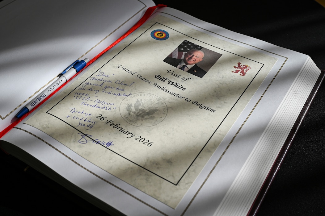 Bill White, U.S. Ambassador to Belgium, writes a farewell message during his base visit.