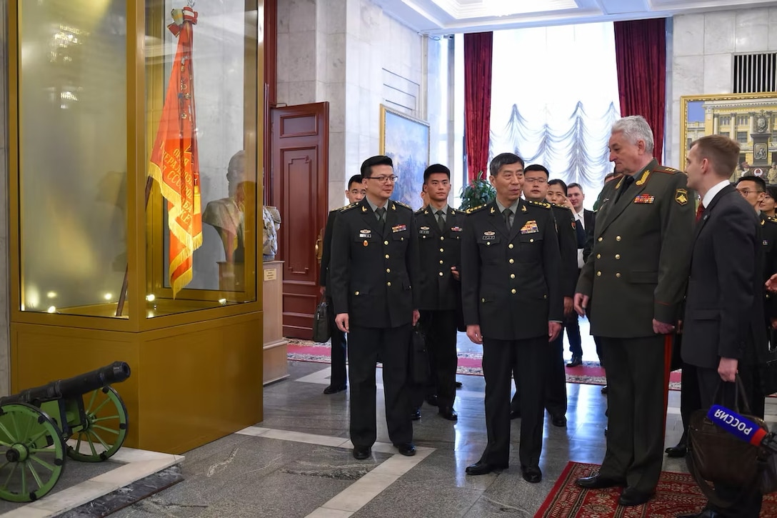 In this handout photo released by Russian Defense Ministry Press Service, Chief of the Military Academy of the General Staff of the Armed Forces of the Russian Federation Col. Gen. Vladimir Zarudnitsky, left, escorts China's Defense Minister Gen. Li Shangfu during a visit to Military Academy of the General Staff of the Armed Forces of the Russian Federation in Moscow, Russia, Monday, April 17, 2023.