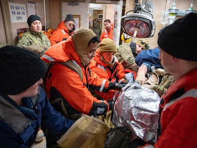 U.S. Navy Sailors assigned to En-route Care System (ERCS) Team 52, and medical professionals from the U.S. Air Force and U.S. Coast Guard treat a patient aboard U.S. Coast Guard Cutter Fir (WLM 212) during a ship-to-shore medical evacuation exercise as part of ARCTIC EDGE 2026 (AE26) in Kodiak, Alaska, Feb. 26, 2026. AE26 is a NORAD and U.S. Northern Command-led homeland defense exercise designed to improve readiness, demonstrate capabilities, and enhance Joint and Allied Force interoperability in the Arctic. (U.S. Navy photo by Mass Communication Specialist 1st Class Abigayle Lutz)