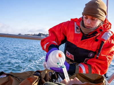 U.S. Navy Lt. Hannah Cunningham, assigned to En-route Care System (ERCS) Team 52, treats a patient aboard a Rigid Hull Inflatable Boat (RHIB) during a ship-to-shore medical evacuation exercise as part of ARCTIC EDGE 2026 (AE26) in Kodiak, Alaska, Feb. 26, 2026. AE26 is a NORAD and U.S. Northern Command-led homeland defense exercise designed to improve readiness, demonstrate capabilities, and enhance Joint and Allied Force interoperability in the Arctic. (U.S. Navy photo by Mass Communication Specialist 1st Class Abigayle Lutz)