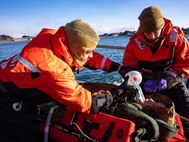 U.S. Navy Hospital Corpsman 1st Class Daniel Rodriguez, left, assigned to En-route Care System (ERCS) Team 52, and U.S. Navy Lt. Hannah Cunningham, right, assigned to ERCS Team 52, treat a patient aboard a Rigid Hull Inflatable Boat (RHIB) during a ship-to-shore medical evacuation exercise as part of ARCTIC EDGE 2026 (AE26) in Kodiak, Alaska, Feb. 26, 2026. AE26 is a NORAD and U.S. Northern Command-led homeland defense exercise designed to improve readiness, demonstrate capabilities, and enhance Joint and Allied Force interoperability in the Arctic. (U.S. Navy photo by Mass Communication Specialist 1st Class Abigayle Lutz)
