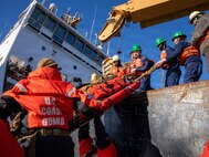 U.S. Navy Sailors assigned to En-route Care System (ERCS) Team 52, and medical professionals from the U.S. Air Force and U.S. Coast Guard transfer a patient from U.S. Coast Guard Cutter Fir (WLM 212) to a Rigid Hull Inflatable Boat (RHIB) during a ship-to-shore medical evacuation exercise as part of ARCTIC EDGE 2026 (AE26) at Kodiak, Alaska, Feb. 26, 2026. AE26 is a NORAD and U.S. Northern Command-led homeland defense exercise designed to improve readiness, demonstrate capabilities, and enhance Joint and Allied Force interoperability in the Arctic. (U.S. Navy photo by Mass Communication Specialist 1st Class Abigayle Lutz)