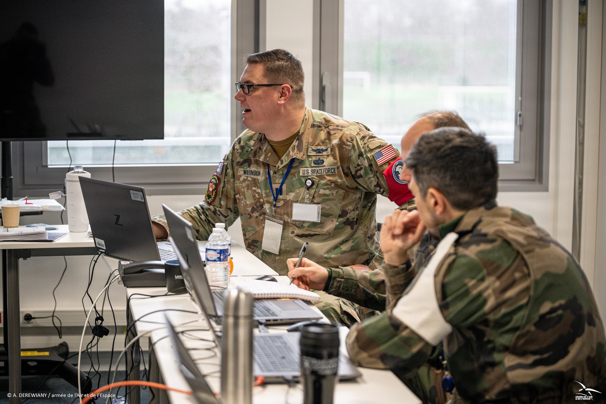 Men and women in uniform at desk
