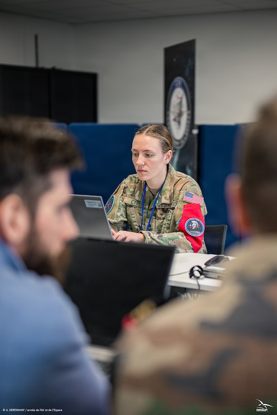 Men and women in uniform at desk