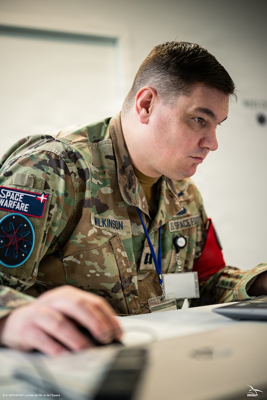 Men and women in uniform at desk