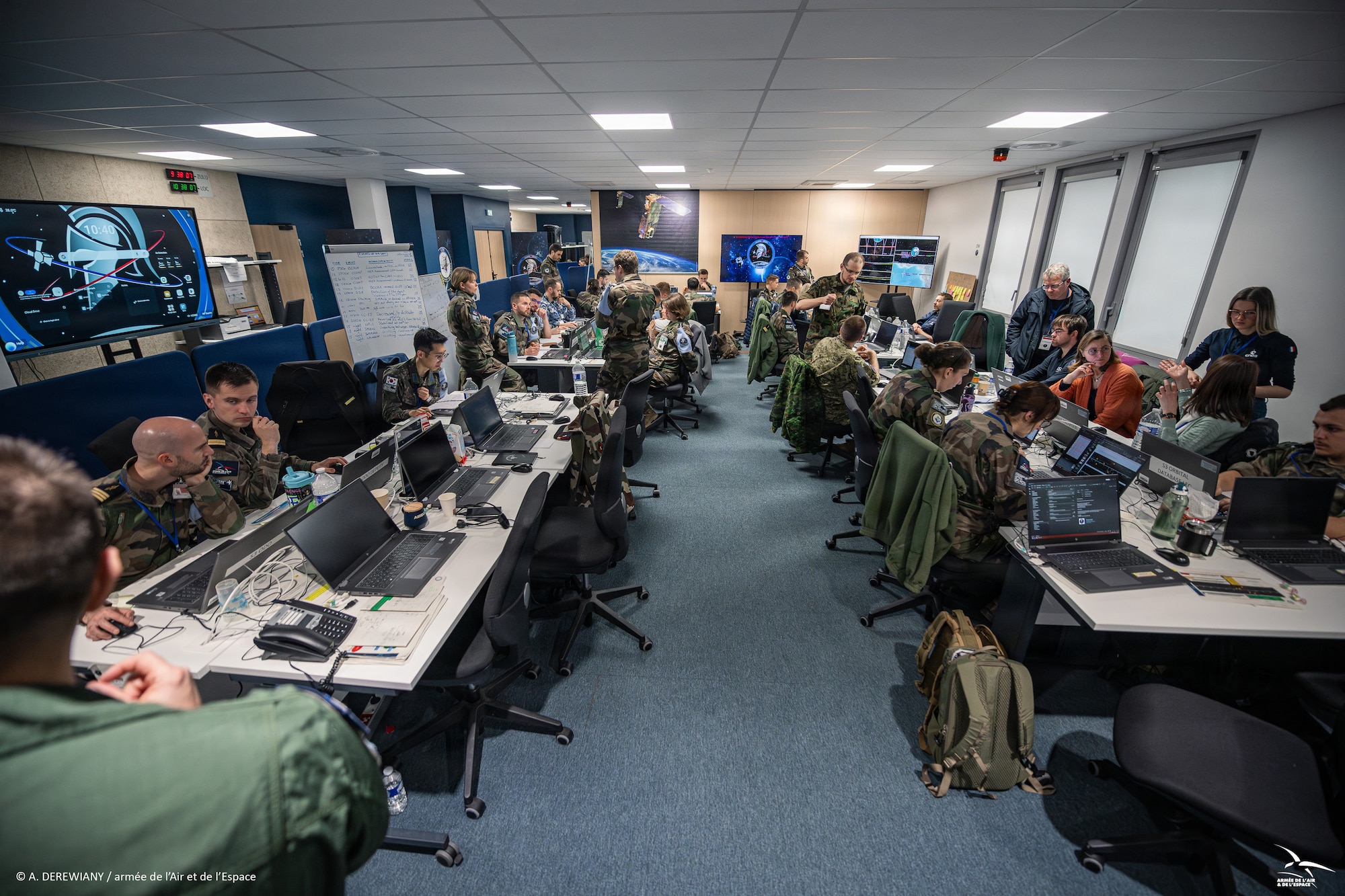 Men and women in uniform at desk