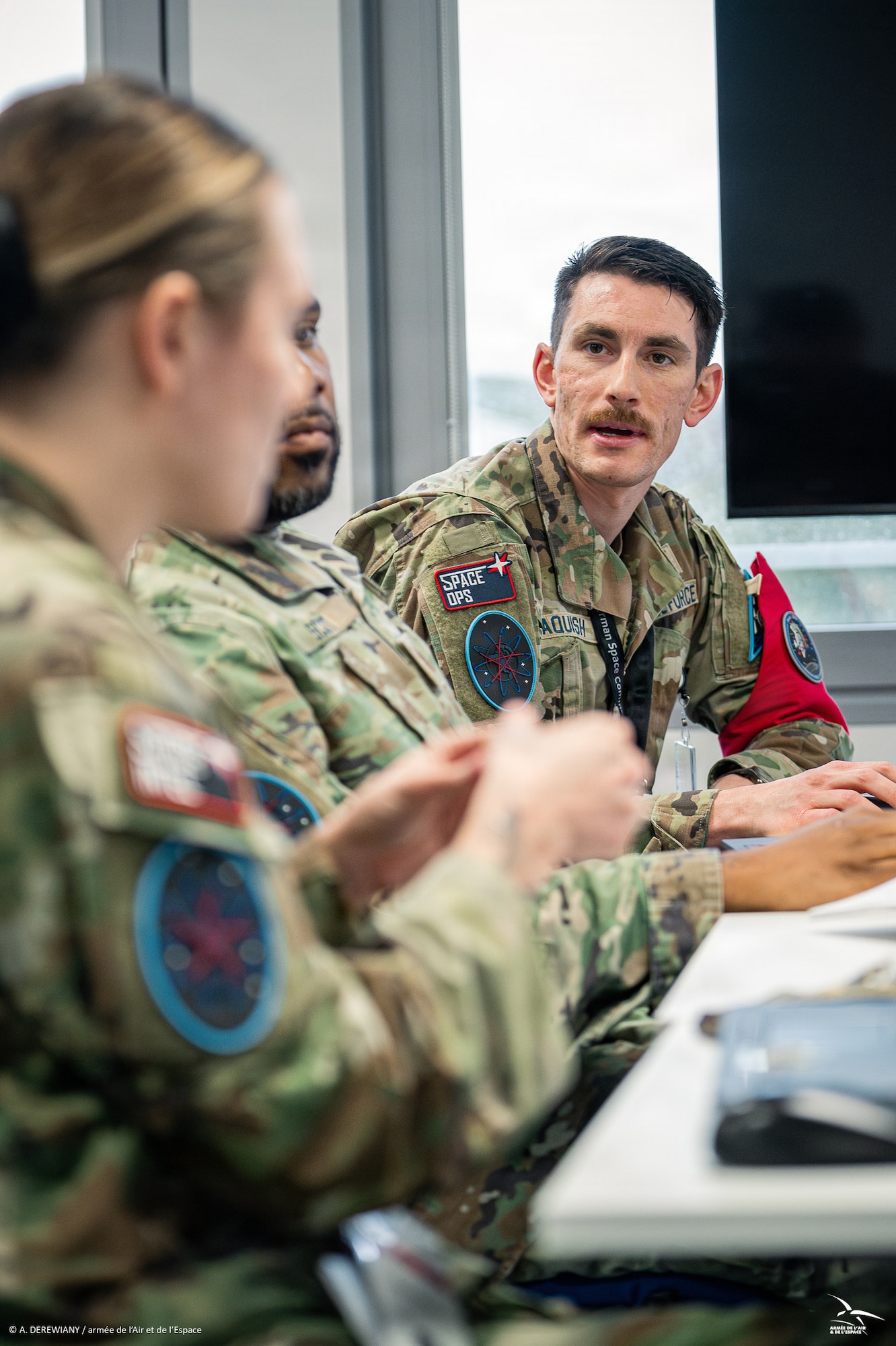 Men and women in uniform at desk