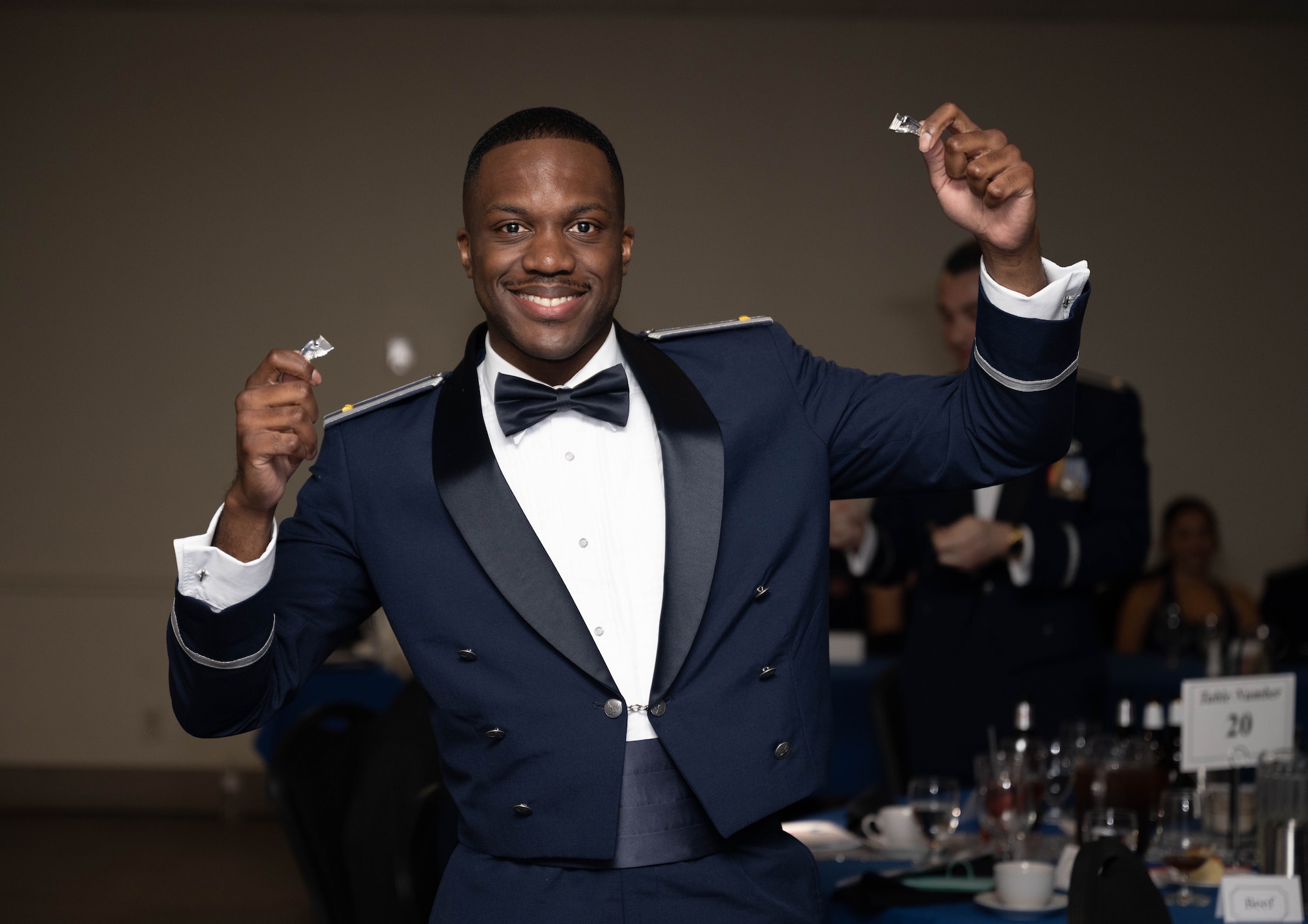 U.S. Air Force 2nd Lt. D’ondre Gumbs, 47th Student Squadron student pilot, holds up his broken silver wings during the graduation ceremony of Class 26-06 at Laughlin Air Force Base, Texas, Feb. 26, 2026. The breaking of silver wings is a tradition dating back to the U.S. Army Air Corps where a pilot's first wings are not to be worn but broken and given to a loved one. (U.S. Air Force photo by Airman 1st Class Darryl Keith)