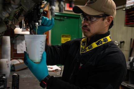 TRFB Team Member mixes paint at the TRFB Paint Shop at TRFB.
