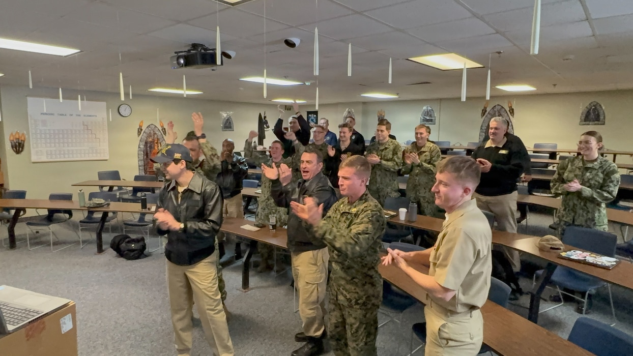 Commander, Naval Surface Force Atlantic, Rear. Adm. Joseph Cahill, celebrates with Naval Reserve Officers’ Training Corps (NROTC) a Midshipman from Maine Maritime Academy after selecting his first warship assignments during the biannual ship selection ceremony, hosted by Navy Personnel Command Pers-41 Surface Warfare Officer Assignments, Feb. 26. For 100 years, NROTC has been one of our Nation’s proven Foundries of Navy and Marine Corps Officers – forging leaders who are united in purpose, resilient in spirit, and committed to ensuring that our Navy and Marine Corps Combat Team remains ready to fight and win tonight, tomorrow, and well into the future.