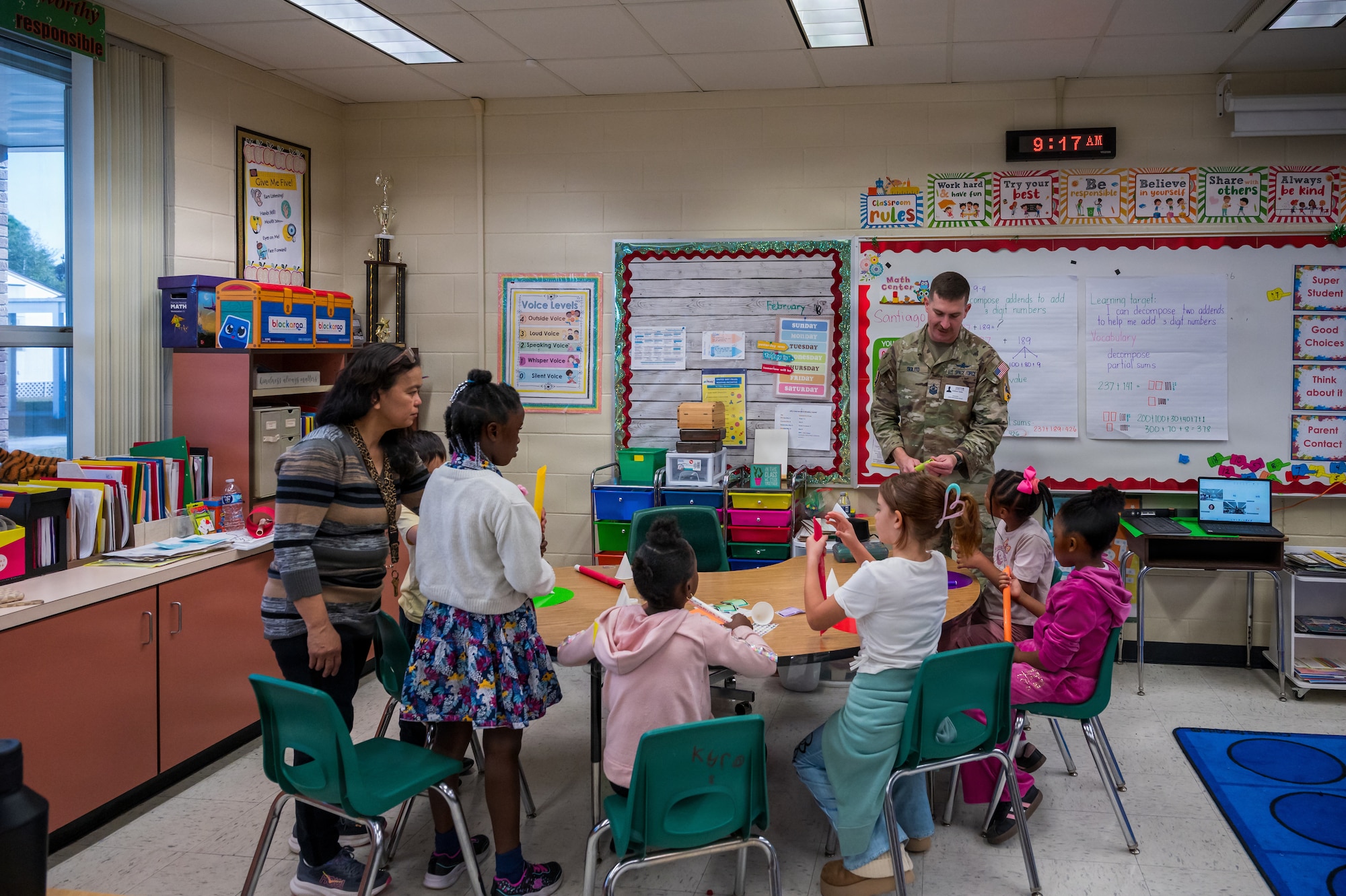U.S. Space Force Master Sgt. Andrew Solito, 1st Range Operations Squadron senior enlisted leader, assists students in building a paper rocket in Brevard County, Florida, Feb. 19, 2026. Guardians partnered with local educators to provide hands-on learning opportunities designed to inspire the next generation of scientists, engineers and space professionals. (U.S. Space Force photo by Gwen Kurzen)