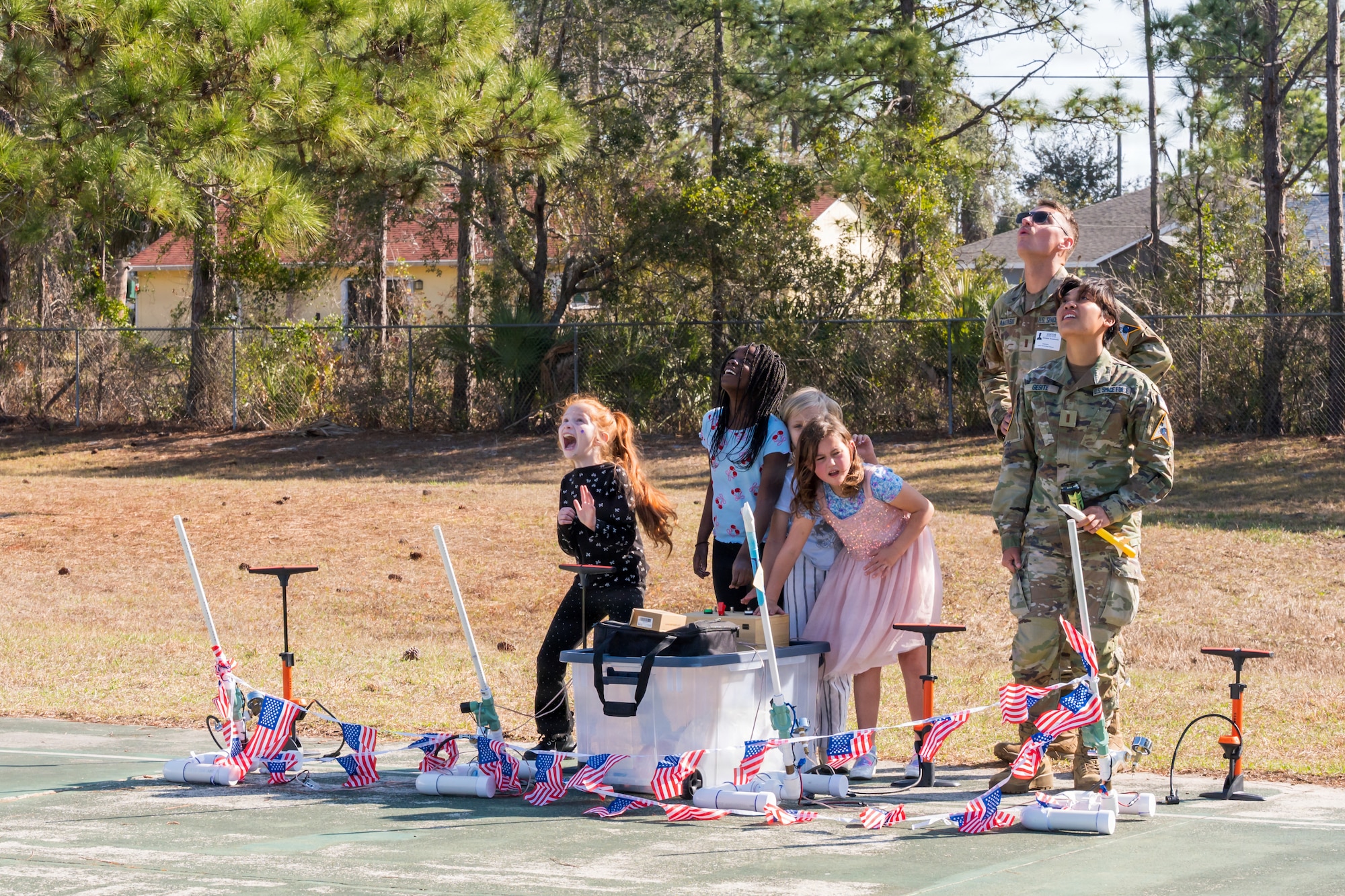 U.S. Space Force 2nd Lt. Dominic Anastasio and 2nd Lt. Athena Gesite, 1st Range Operations Squadron range operations commanders in training, observe as students launch paper rockets in Brevard County, Florida, Feb. 19, 2026. Through hands-on activities like rocket design and launch demonstrations, Guardians helped students explore basic engineering principles while strengthening connections between the Space Force and the local community that supports the Eastern Range mission. (U.S. Space Force photo by Gwen Kurzen)