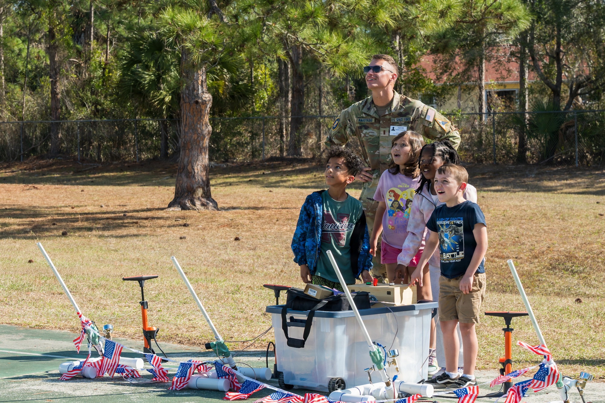 U.S. Space Force 2nd Lt. Dominic Anastasio, 1st Range Operations Squadron range operations commander in training, observes as students launch paper rockets in Brevard County, Florida, Feb. 19, 2026. Through hands-on activities like rocket design and launch demonstrations, Guardians helped students explore basic engineering principles while strengthening connections between the Space Force and the local community that supports the Eastern Range mission. (U.S. Space Force photo by Gwen Kurzen)