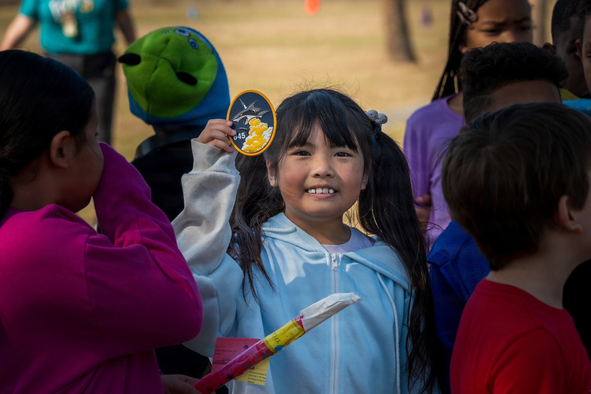 A student holds up a 645th Cyberspace Squadron patch during a STEM outreach event in Brevard County, Florida, Feb. 19, 2026. Guardians engaged students through hands-on rocket activities and discussions about space and cyber operations, helping connect classroom learning to the missions supporting the Eastern Range and national defense. (U.S. Space Force photo by Gwen Kurzen)