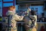 U.S. Air Force Airman 1st Class Xavier Gordan, left, and Airman 1st Class Autumn Lopez, right, both fire protection specialists assigned to the 165th Civil Engineer Squadron, 165th Airlift Wing, Georgia Air National Guard, stow a fire hose after responding to a simulated aircraft fire during an employment exercise at the Savannah Air National Guard Base, Georgia, Feb. 8, 2026. This exercise reinforced technical proficiency to execute aircraft fire response operations in degraded and congested conditions. Photo by Senior Airman Christa Ross.