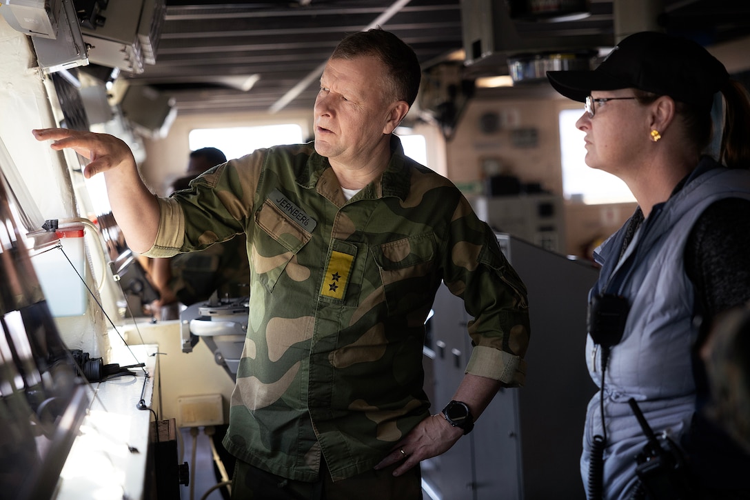Norway Army Maj. Gen. Anders Jernberg, commander of the Norwegian Defense Logistics Organization, discuses crane operations with Deatra Thompson, contracted captain of the USNS Dahl, while aboard the maritime prepositioning ship Feb. 27, 2026, at Marine Corps Support Facility Blount Island in Jacksonville, Florida. The visit highlighted Arctic prepositioning and allied sustainment supporting NATO readiness in the High North. (U.S. Marine Corps photo by Dustin Senger)