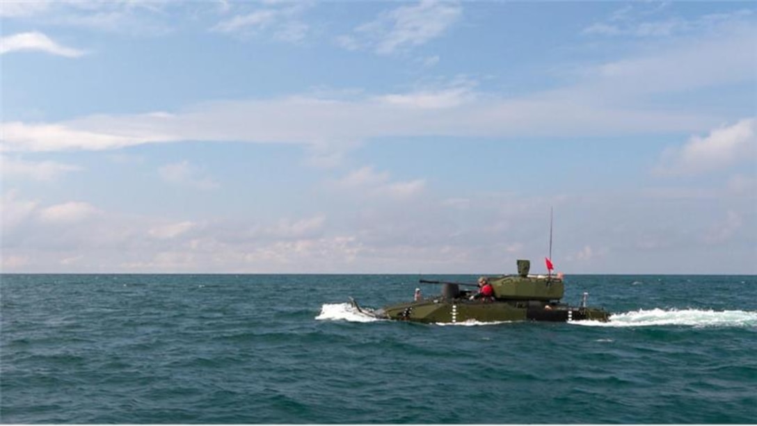 The Advanced Reconnaissance Vehicle wading in blue ocean water completing a swim test during a training exercise