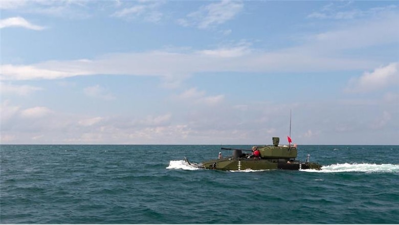 The Advanced Reconnaissance Vehicle wading in blue ocean water completing a swim test during a training exercise