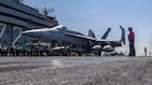 An F/A-18E Super Hornet, attached to Strike Fighter Squadron (VFA) 151, taxis the flight deck of Nimitz-class aircraft carrier USS Abraham Lincoln (CVN 72) in support of Operation Epic Fury, March 2, 2026. Abraham Lincoln is deployed to the U.S. 5th Fleet area of operations to support maritime security and stability in the Middle East. (U.S. Navy photo)