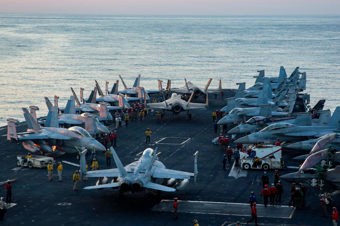 U.S. Sailors taxi aircraft to a staging point on the flight deck of Nimitz-class aircraft carrier USS Abraham Lincoln (CVN 72) in support of Operation Epic Fury, Feb. 28, 2026. (U.S. Navy photo)
