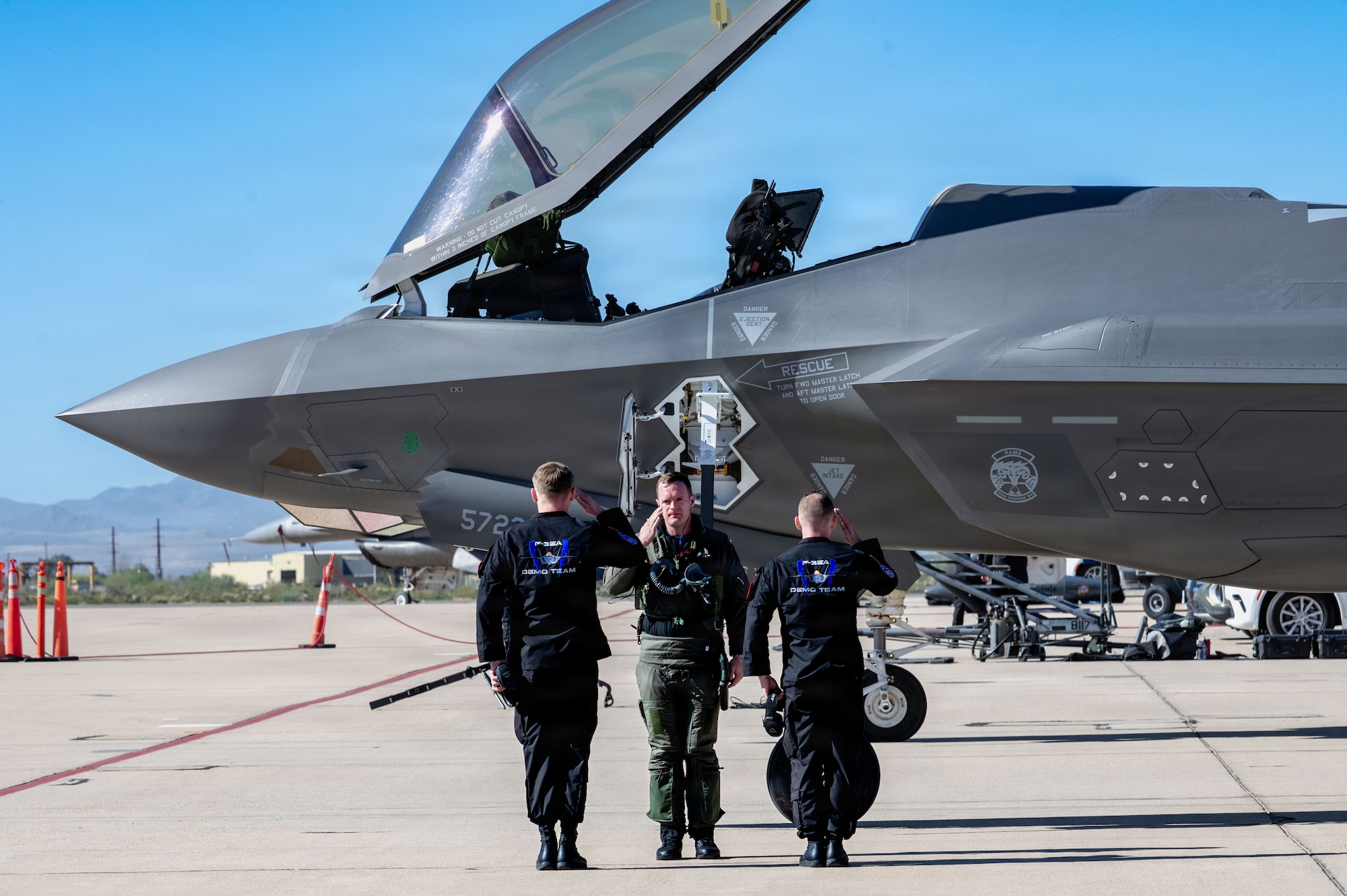 U.S. Air Force Maj. Sean “Rambo” Loughlin, F-35A Lightning II Demonstration Team pilot, exchanges a salute with the team’s crew chiefs after a successful aerial demonstration during the Heritage Flight Training Course at Davis-Monthan Air Force Base, Arizona, Feb. 27, 2026. The F-35A Demonstration Team travels to air shows across the globe to inspire the next generation of Airmen and demonstrate the professional standards of the U.S. Air Force. (U.S. Air Force photo by Senior Airman Jasmyne Bridgers-Matos)