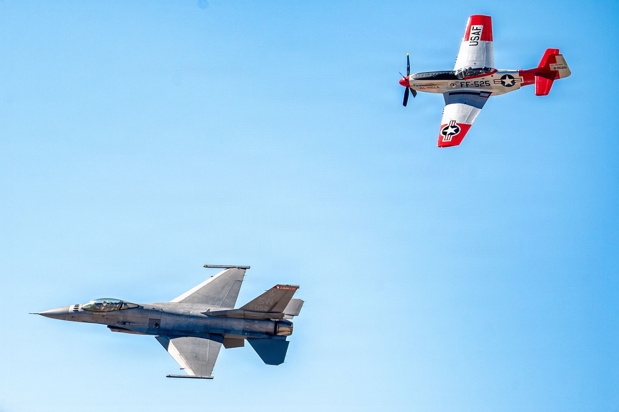 U.S. Maj. Taylor “FEMA” Heister, F-16 Viper Demonstration Team commander and pilot, flies in a heritage formation with P-51 Mustang aircraft “Val Halla” during the Heritage Flight Training Course at Davis-Monthan Air Force Base, Arizona, Feb. 28, 2026. The course serves as a certification forum, allowing active-duty demonstration pilots to practice flying in close proximity to civilian-piloted historic aircraft. (U.S. Air Force photo by Senior Airman Jasmyne Bridgers-Matos)