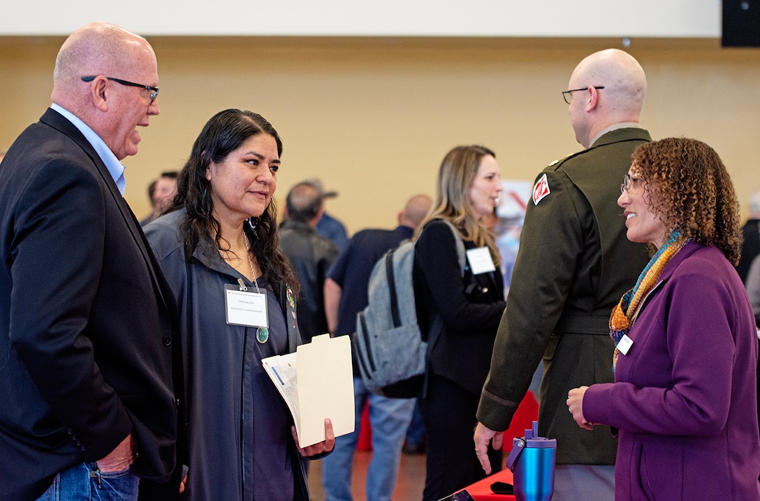 Crystalin Medrano, right, chief of the district’s Emergency Management Branch, speaks with attendees during the district’s annual Business Opportunities Open House at the Sid Cutter Pilot’s Pavilion at the Balloon Fiesta Park in Albuquerque, N.M., Feb. 25, 2026.