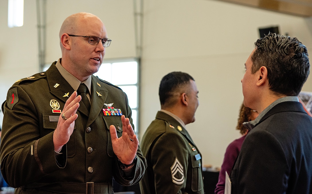 Maj. Matthew Nulk, left, contract specialist in the district’s Contracting Execution Branch, speaks with one of the attendees during the district’s annual Business Opportunities Open House at the Sid Cutter Pilot’s Pavilion at the Balloon Fiesta Park in Albuquerque, N.M., Feb. 25, 2026.