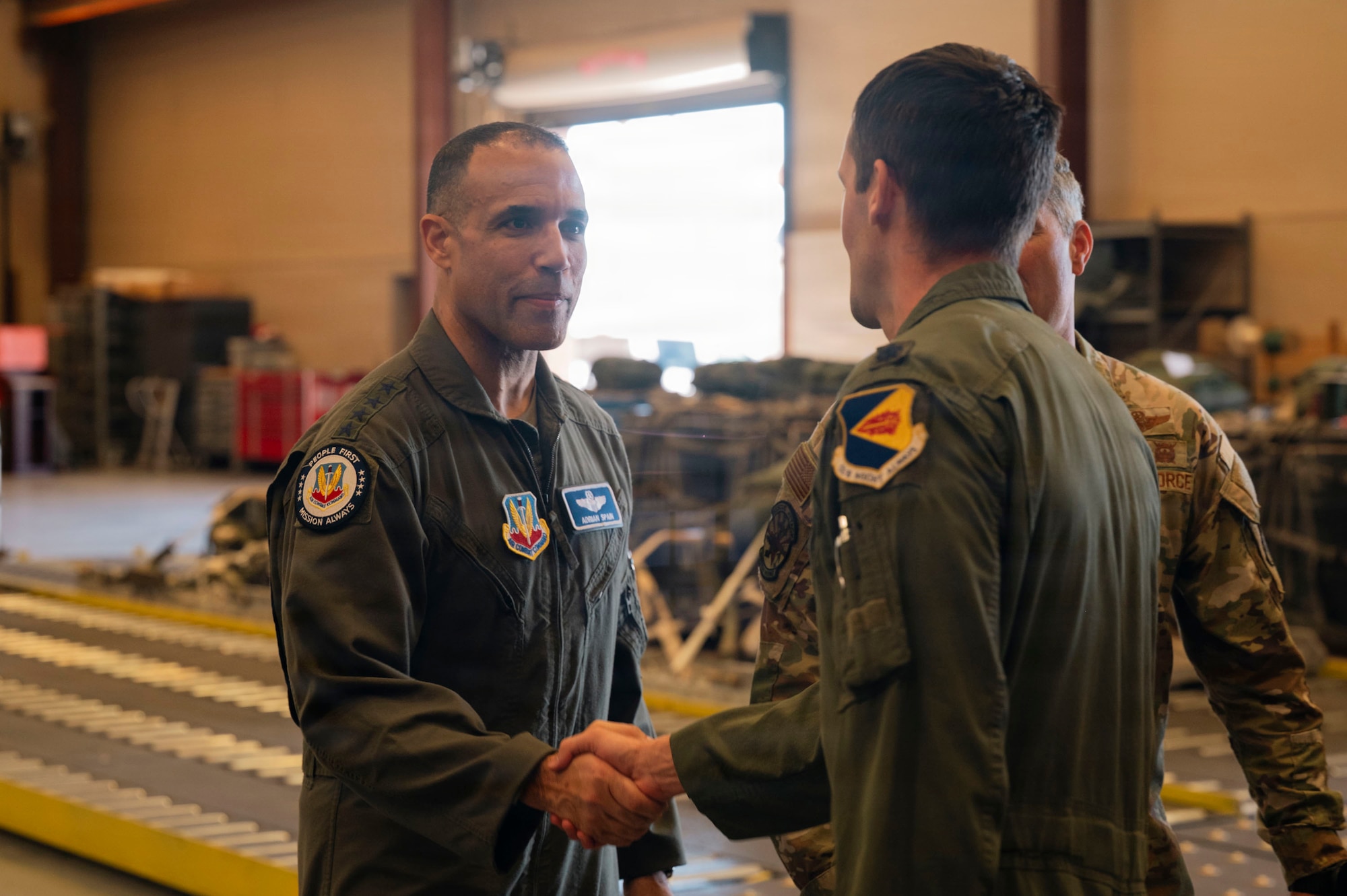 U.S. Air Force Gen. Adrian Spain, commander of Air Combat Command, shakes hands with an Airman assigned to the 563rd Rescue Group at Davis-Monthan Air Force Base, Arizona, Feb. 26, 2026. Spain thanked the Airmen for their service during a civilian search and rescue mission in Mexico. (U.S. Air Force photo by Airman 1st Class Samantha Melecio)