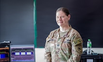 U.S. Army Capt. Brittany Chapman-Freed, space crew officer in charge assigned to 3rd Multi-Domain Task Force, stands beside a spectrum monitoring system during Exercise Cobra Gold 2026 at U-Tapao Royal Thai Navy Airfield, Thailand, Feb. 25, 2026.