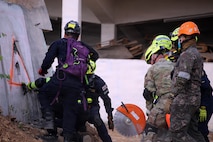 U.S. Army Maj. Luis Torres, Washington National Guard Homeland Response Force, cuts a concrete wall with the Bangkok Fire and Rescue Department during the Humanitarian Assistance Disaster Relief Demonstration, part of Exercise Cobra Gold 26 at the Disaster Relief Training Centre, Phanom Sarakham District, Chachoengsao, Thailand, Feb. 27, 2026.