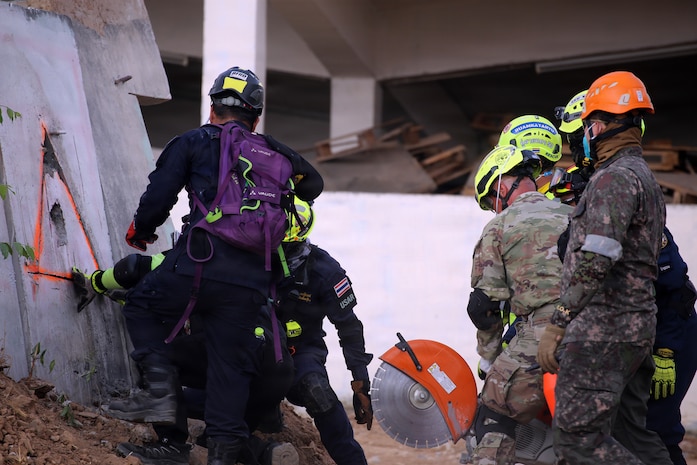 U.S. Army Maj. Luis Torres, Washington National Guard Homeland Response Force, cuts a concrete wall with the Bangkok Fire and Rescue Department during the Humanitarian Assistance Disaster Relief Demonstration, part of Exercise Cobra Gold 26 at the Disaster Relief Training Centre, Phanom Sarakham District, Chachoengsao, Thailand, Feb. 27, 2026.