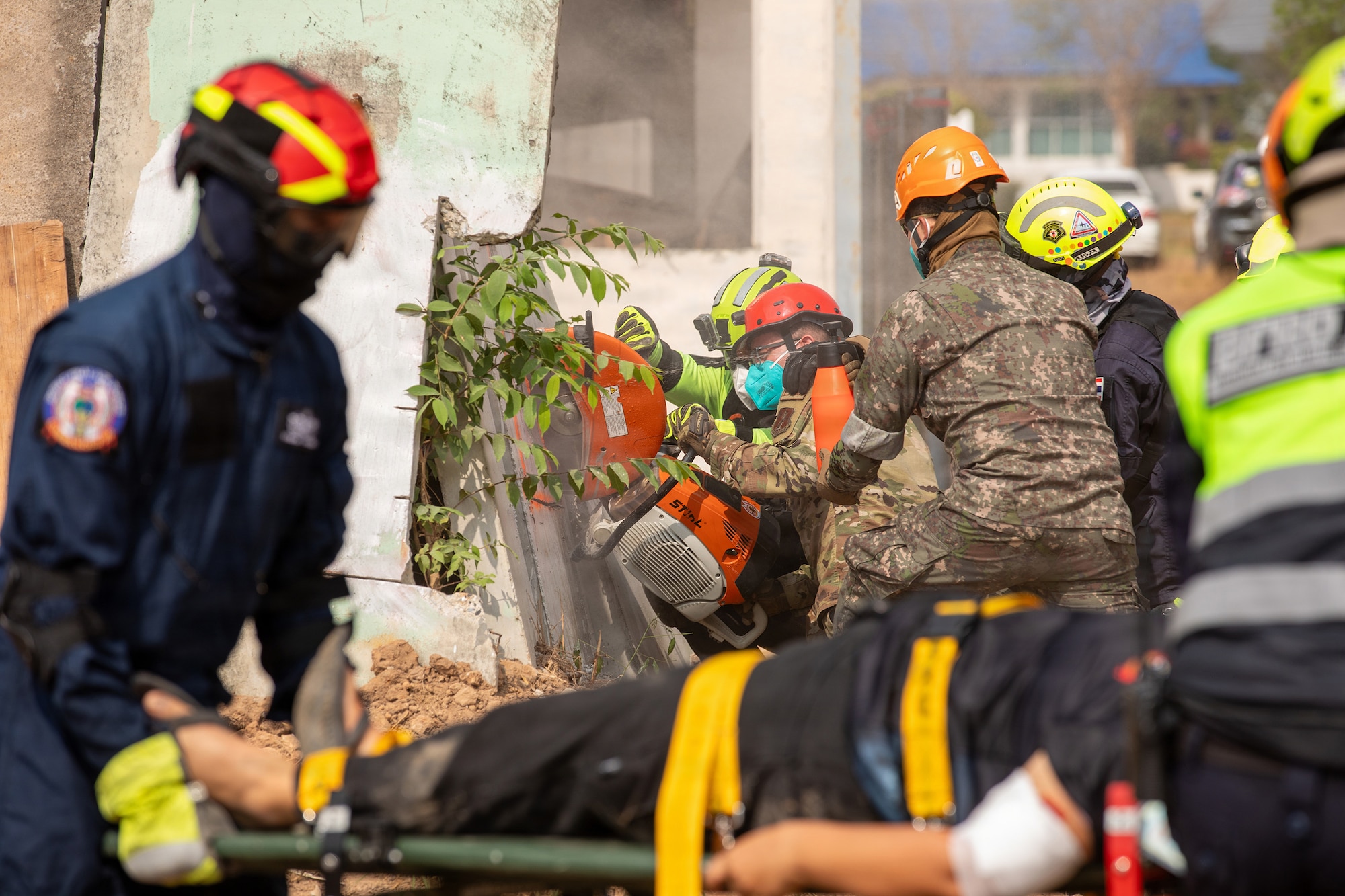 U.S. Air Force Tech. Sgt. Waylon Dashiell, 141st Civil Engineers, Washington Air National Guard, cuts a concrete wall alongside the Bangkok Fire and Rescue Department during the humanitarian assistance disaster relief demonstration, part of Exercise Cobra Gold 2026 at the Disaster Relief Training Centre, Phanom Sarakham District, Chachoengsao, Thailand, Feb. 27, 2026.