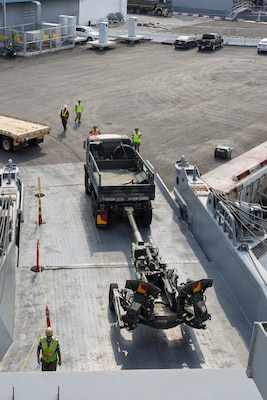 Military equipment is discharged from Military Sealift Command (MSC) chartered steam ship Cape Island (T-AKR 10) at the port of Chuk Samet, Sattahip, Thailand, Feb. 18, 2026, during an offload of equipment that will be used in Joint Exercise Cobra Gold 2026.