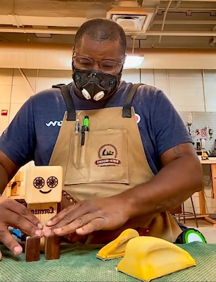 Photo of Marcellus woodworking.