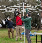 Observers put up a tent during a training exercise.