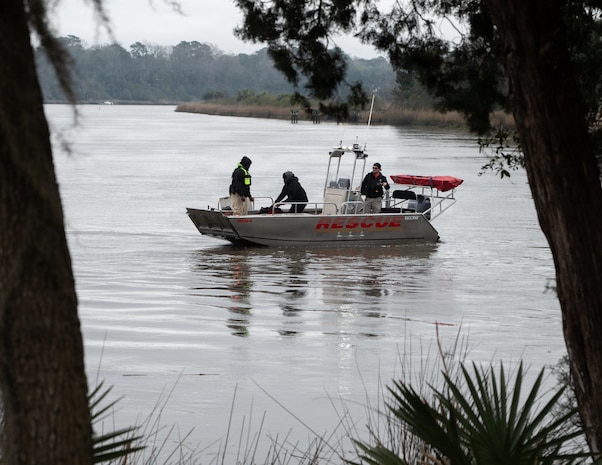 A rescue squad boat crew searche the river.