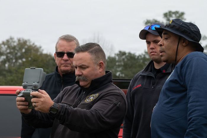 Fire Department members operate a drone.