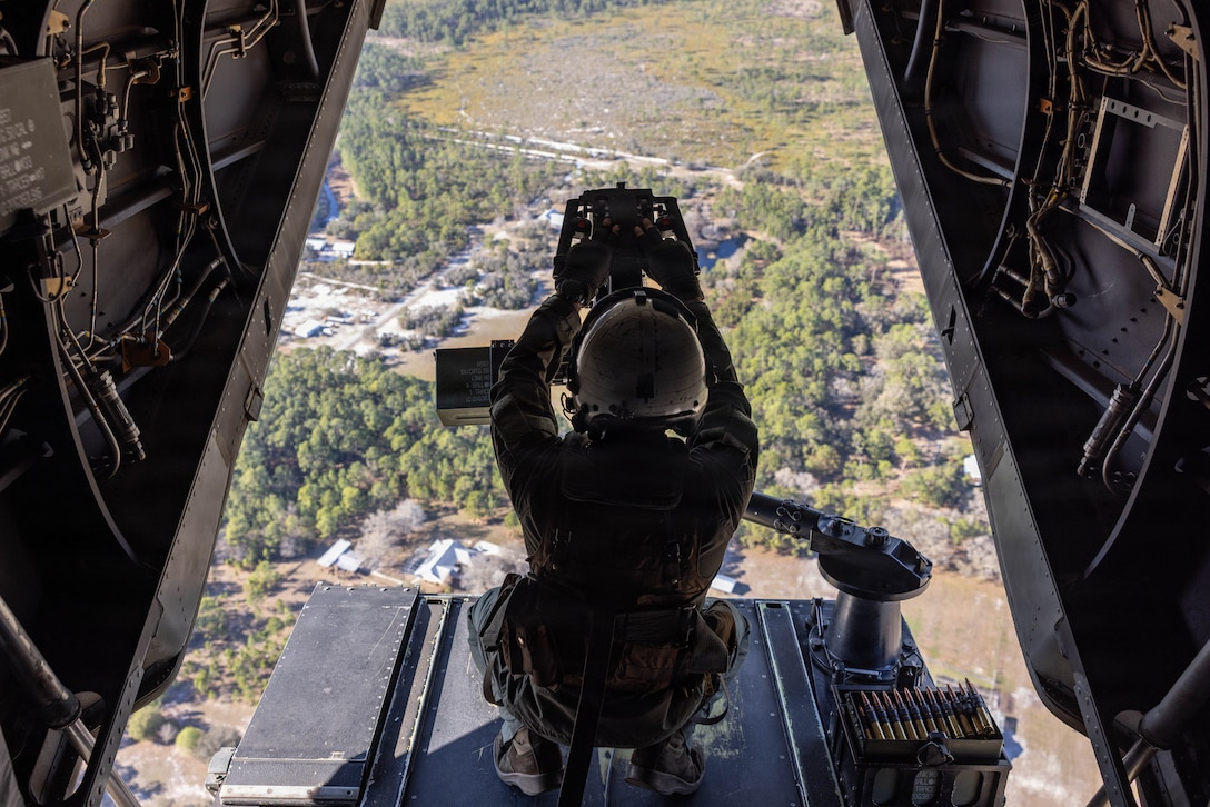 U.S. Marine Corps Cpl. Gavin McSwain, from North Carolina, a tiltrotor mechanic with Marine Medium Tiltrotor Squadron (VMM) 261, Marine Aircraft Group 26, 2nd Marine Aircraft Wing, looks out the back of an MV-22B Osprey during a flight near Jacksonville, Florida, Feb. 25, 2026.  MAG-29 Distributed Aviation Operations Exercise is a multi-week exercise designed to distribute command and control of aviation forces, pushing authorities to the lowest levels while keeping forces moving between airfields and air sites.  MAG-29 DAO Exercise is scheduled to take place across the southeastern U.S. and the Caribbean, including North Carolina, South Carolina, Georgia, Florida, and The Bahamas. (U.S. Marine Corps photo by Lance Cpl. Orlanys Diaz Figueroa)