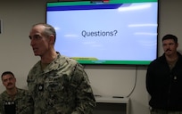 Cmdr. Avondoglio, commanding officer of Navy Reserve Cyber Protection Team Pensacola, speaks to participating cyber protection teams during Mobilization Exercise (MOBEX) January 2026.  MOBEX’s translate classroom instruction into operational readiness in support of reserve integration for future operations.  (U.S. Navy photo by Intelligence Specialist 3rd Class Hennessy)