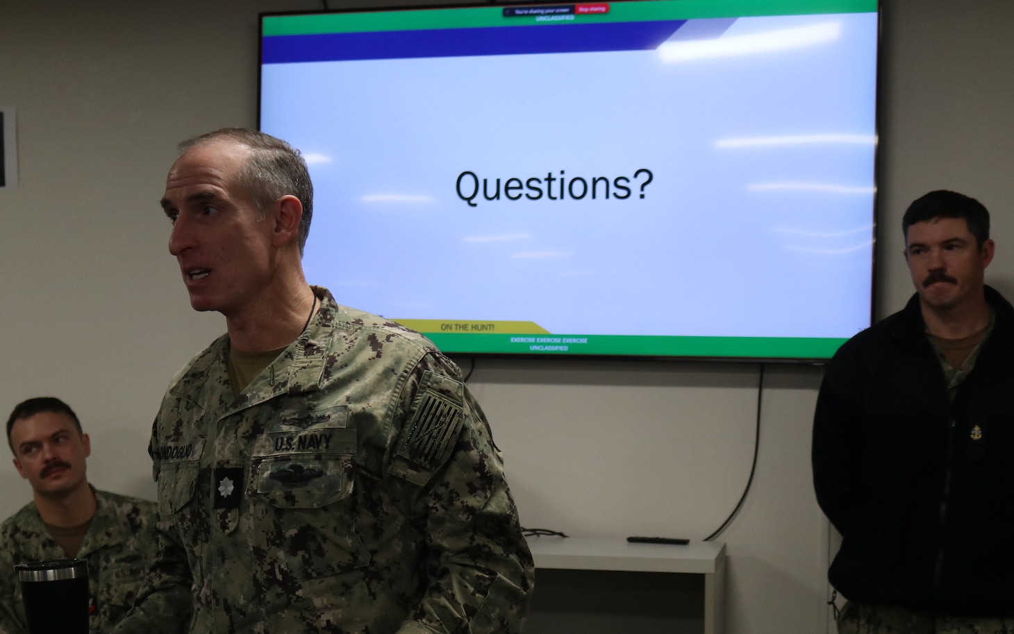 Cmdr. Avondoglio, commanding officer of Navy Reserve Cyber Protection Team Pensacola, speaks to participating cyber protection teams during Mobilization Exercise (MOBEX) January 2026.  MOBEX’s translate classroom instruction into operational readiness in support of reserve integration for future operations.  (U.S. Navy photo by Intelligence Specialist 3rd Class Hennessy)