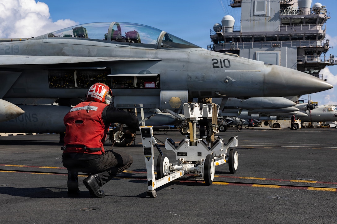 A U.S. Sailor performs a visual inspection on an F/A-18F Super Hornet aircraft, attached to Strike Fighter Squadron 213, on the flight deck of the world’s largest aircraft carrier, USS Gerald R. Ford (CVN 78), while operating in support of Operation Epic Fury in the Eastern Mediterranean Sea, March 2, 2026. (U.S. Navy photo)