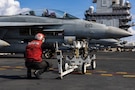 A U.S. Sailor performs a visual inspection on an F/A-18F Super Hornet aircraft, attached to Strike Fighter Squadron 213, on the flight deck of the world’s largest aircraft carrier, USS Gerald R. Ford (CVN 78), while operating in support of Operation Epic Fury in the Eastern Mediterranean Sea, March 2, 2026. (U.S. Navy photo)