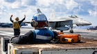 A U.S. Sailor observes an F/A-18E Super Hornet aircraft, attached to Strike Fighter Squadron 37, land on the flight deck of the world's largest aircraft carrier, USS Gerald R. Ford (CVN 78), while operating in support of Operation Epic Fury in the Eastern Mediterranean Sea, March 2, 2026. (U.S. Navy photo)