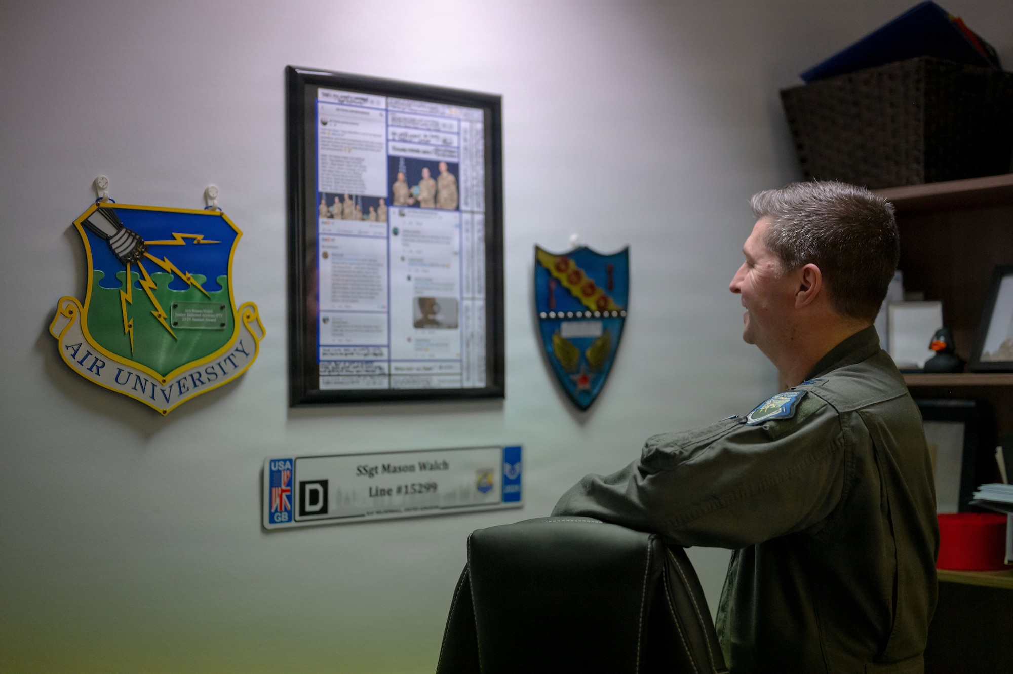U.S. Air Force Col. Steven Byrum, 100th Air Refueling Wing commander, admires Senior Airman Mason Walch’s, 100th Air Refueling Wing civil law paralegal, personal items on display at RAF Mildenhall, England, Feb. 23, 2026.