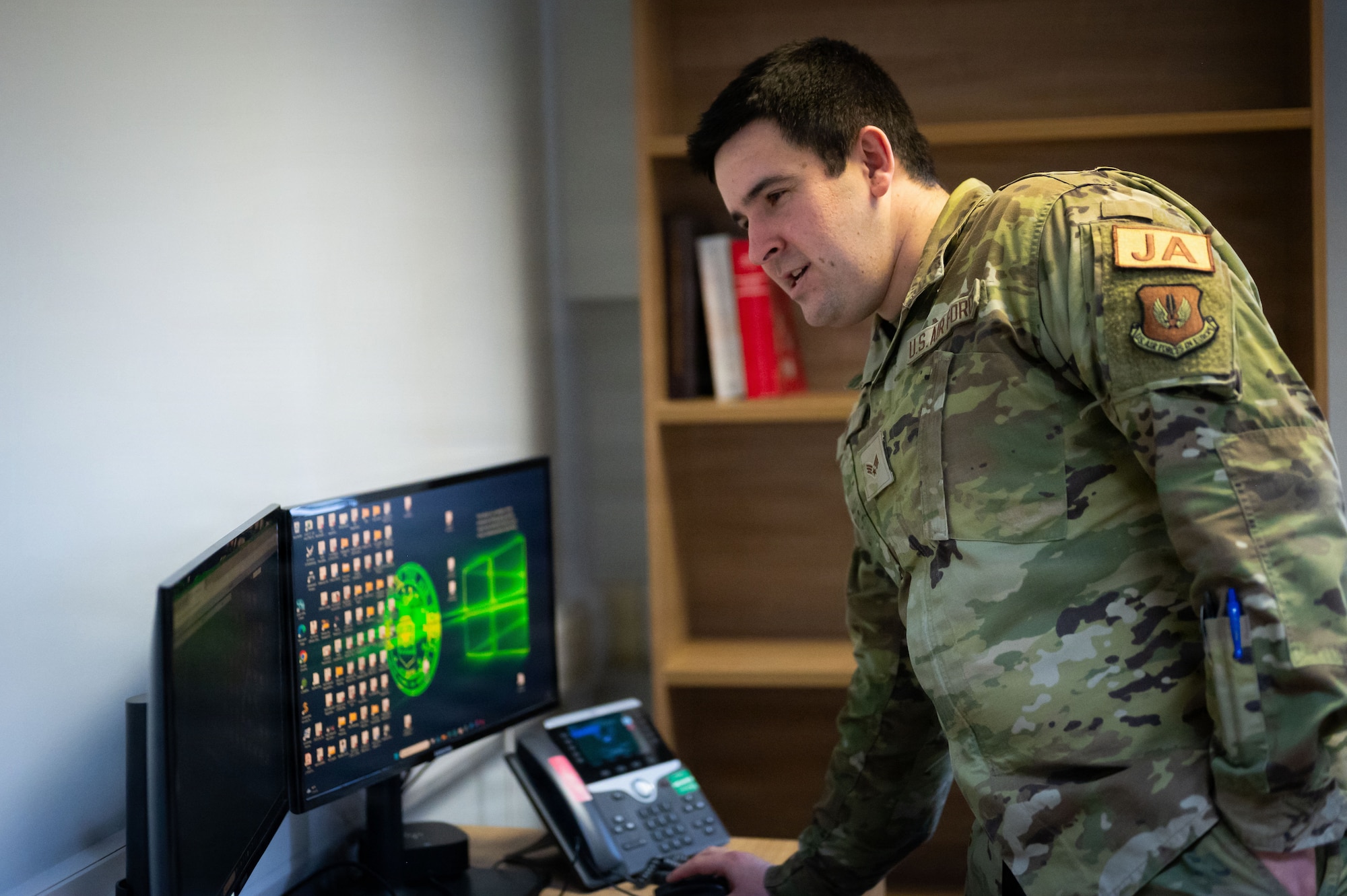 U.S. Air Force Senior Airman Mason Walch, 100th Air Refueling Wing civil law paralegal, prepares a work environment for the hands-on portion of the day in the life integration with Col. Steven Byrum, 100th ARW commander, at RAF Mildenhall, England, Feb. 23, 2026.